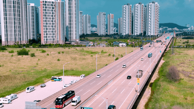 Highway with cars and tall buildings