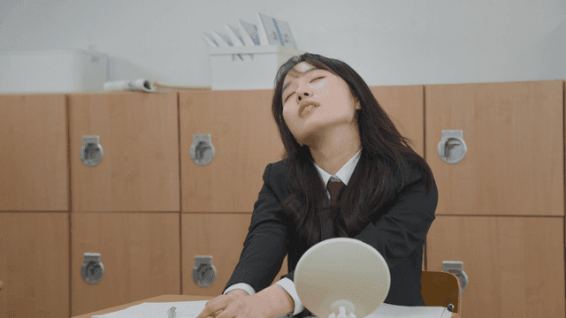 Student in a classroom looking tired