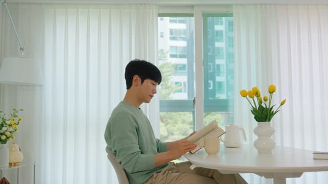 Man Reading a Book While Drinking Coffee