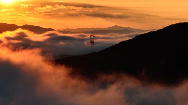 Sunset over mountains with clouds