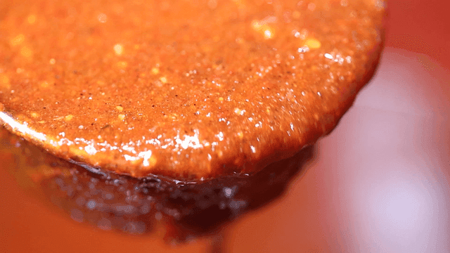 Ladle containing spicy gochujang sauce