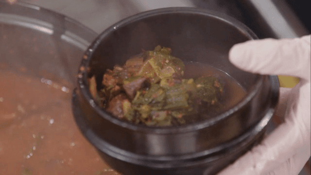 Putting napa cabbage seonji soup in an earthen pot
