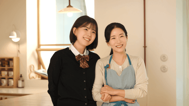 Smiling mother and daughter in cozy home