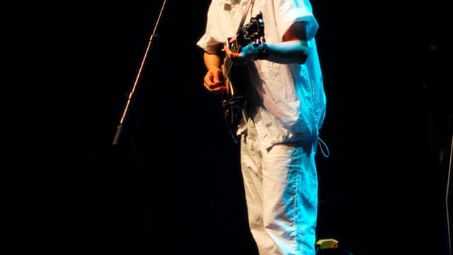 Guitarist Tuning Guitar on Stage