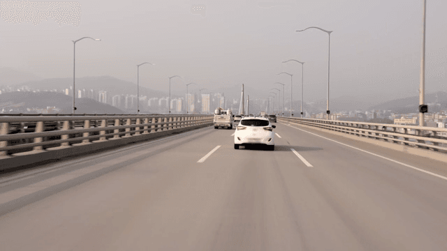 Cars driving on a bridge towards the city