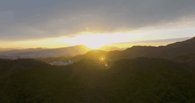 Sunset over mountains and cityscape