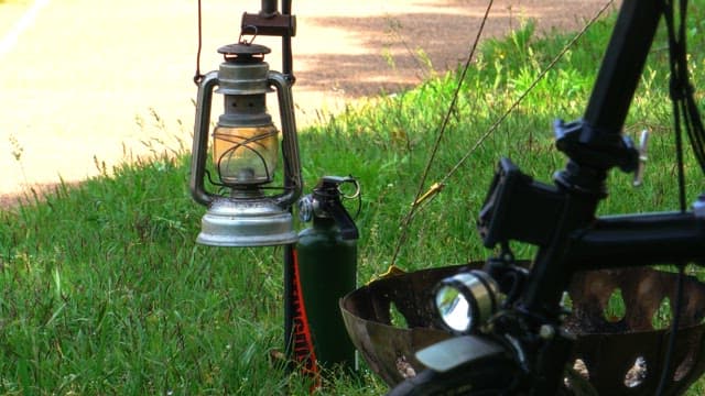 Camping lantern installed on green lawn