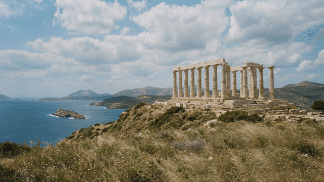 Ancient Temple of Poseidon by sea under blue sky