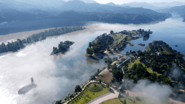 Quiet river landscape shrouded in fog.