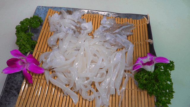 Fresh squid sashimi on bamboo mat