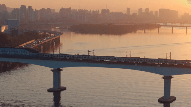 Bridge over a river with city skyline