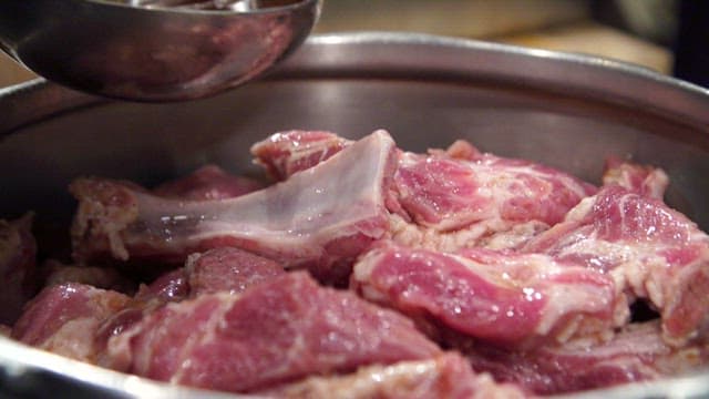 Marinating pork ribs with sauce in a bowl