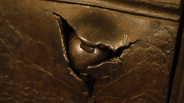 Close-up of a cracked bronze sculpture