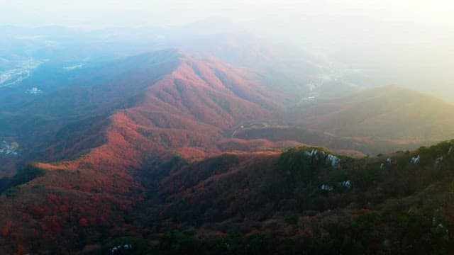 Sunlight shining on the autumn mountain covered in colorful autumn leaves