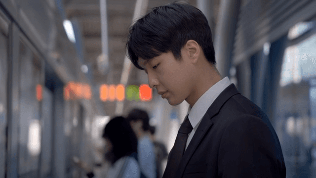 Office worker man waiting for subway at crowded subway station