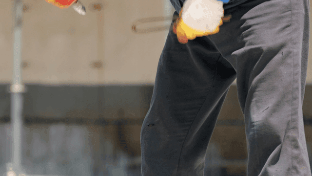 Construction worker bending over at site