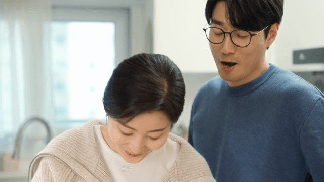 Couple preparing and tasting fresh cucumber