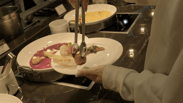 Person who places food on plates at buffet