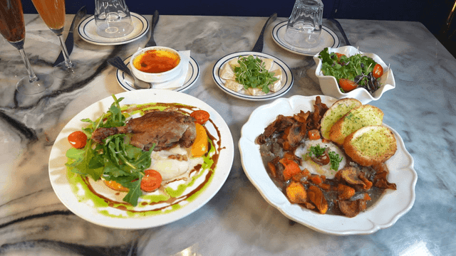 Restaurant table with duck confit and beef bourguignon