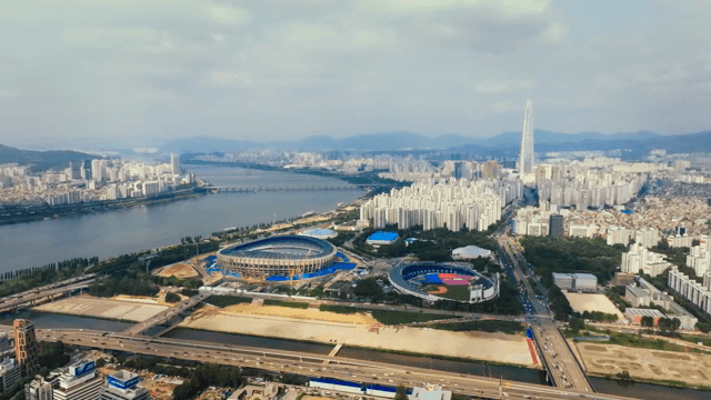 A cityscape with a tall building and river