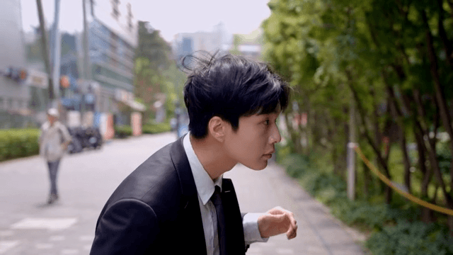 Office worker walking down the street after fixing his hair
