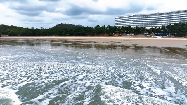 Serene beach with a distant hotel