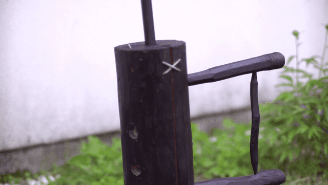 Unique wooden bicycle sculpture in a garden