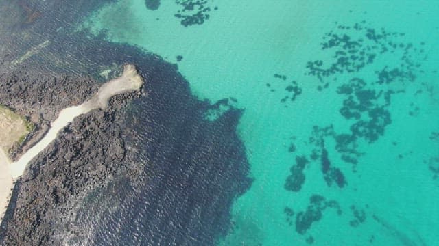 Clear turquoise sea with rocky coastline