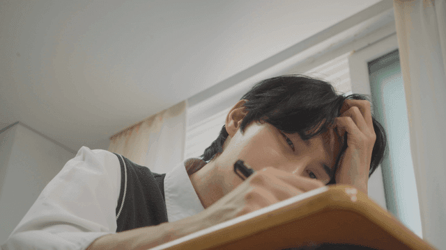 시간을 보며 초조하게 문제를 푸는 남학생