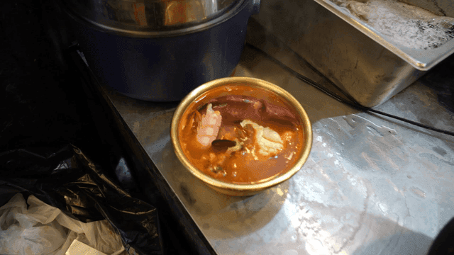 Seafood ramen with squid on top in pot