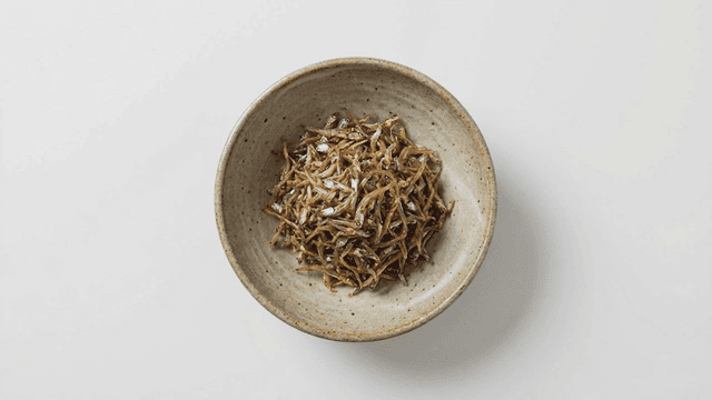 Bowl containing roasted anchovies