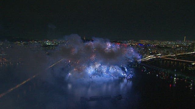 Spectacular Fireworks over the Cityscape and River at Night