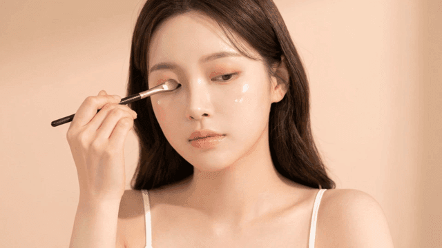 Woman applying eyeshadow with brush