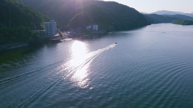 Boat Sailing through the Waters of a Calm Lake