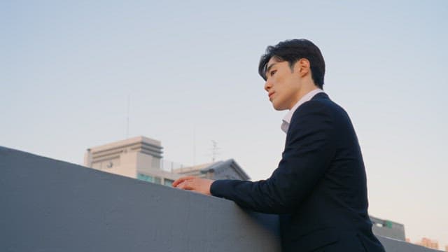 Man in a suit on a rooftop