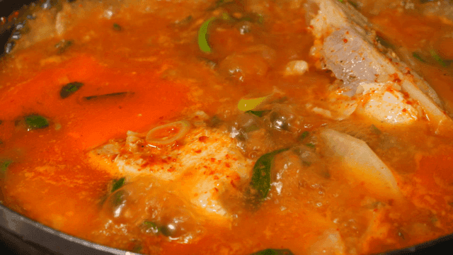Spicy fish stew boiling in a pot