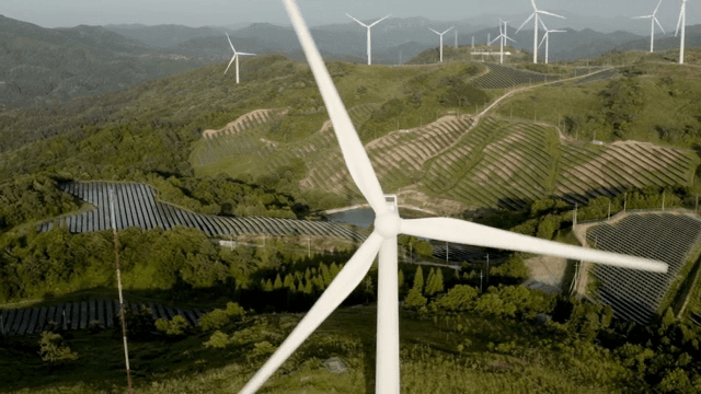 Wind turbine in a lush green mountain area