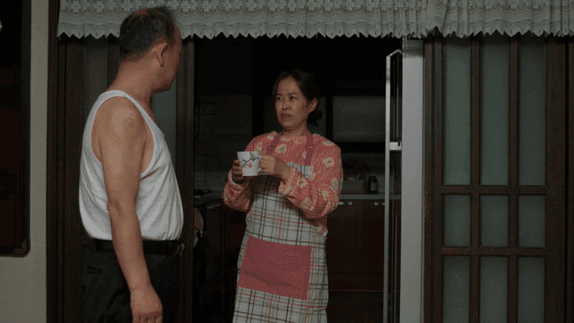 Wife handing over water and husband leaving