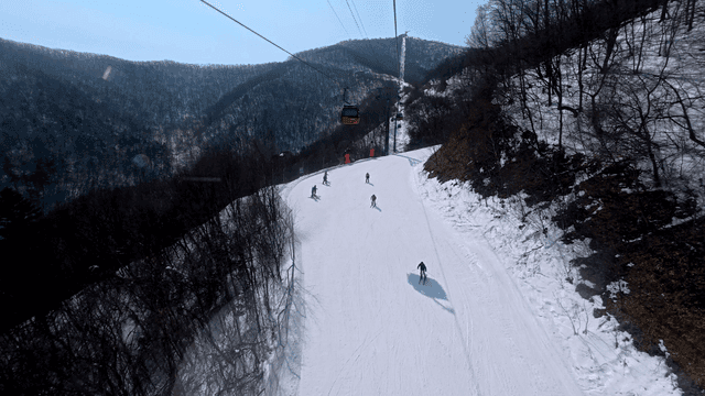 Skiers on a snowy mountain slope