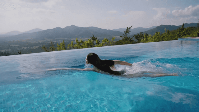 Woman enjoying swim in outdoor swimming pool