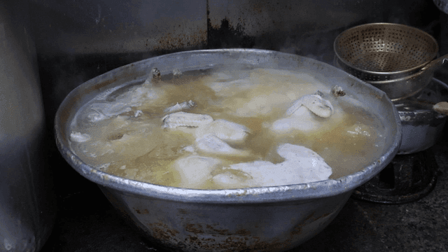 큰 냄비에서 끓고 있는 닭고기들