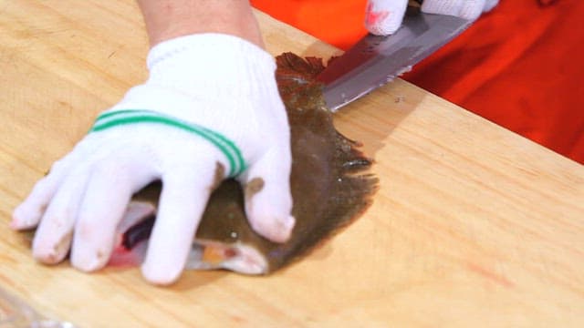 Filleting flatfish on a wooden cutting board