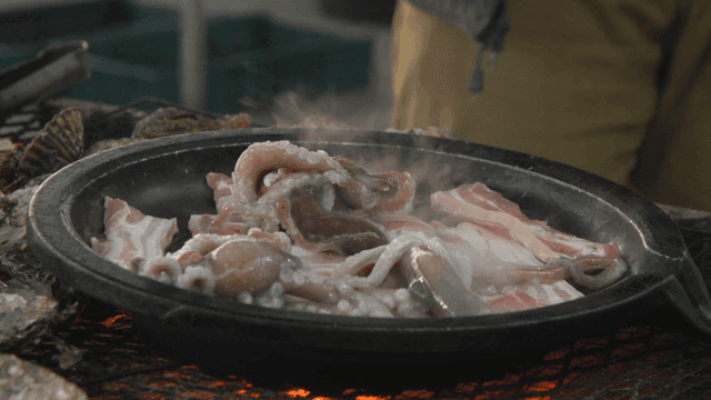 Octopus and pork belly grilling on pan