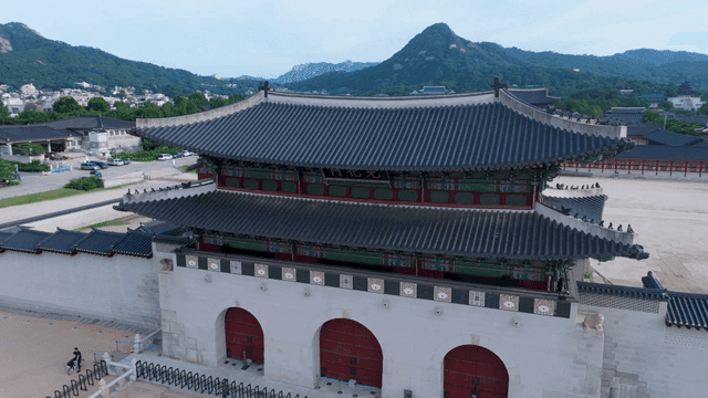Traditional Korean palace with mountain backdrop
