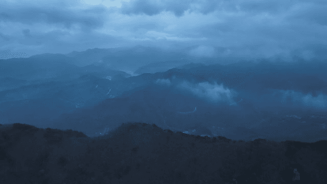 Misty mountains under a cloudy sky