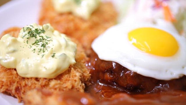 Delicious fried cutlet with sauce and fried egg