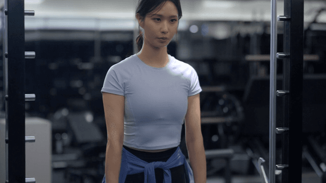 Young woman doing deadlift in gym
