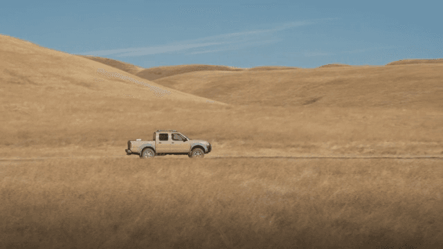 Truck driving through dry grasslands