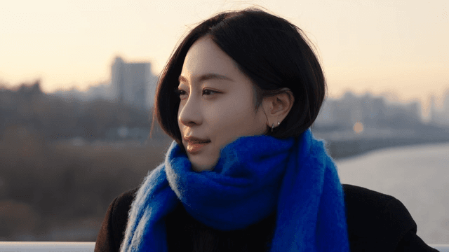 Woman in a blue scarf on a river