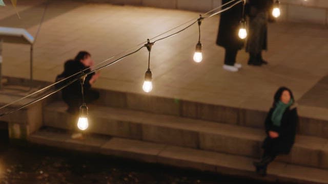 People enjoying the colorful lanterns that light up cheonggyecheon stream